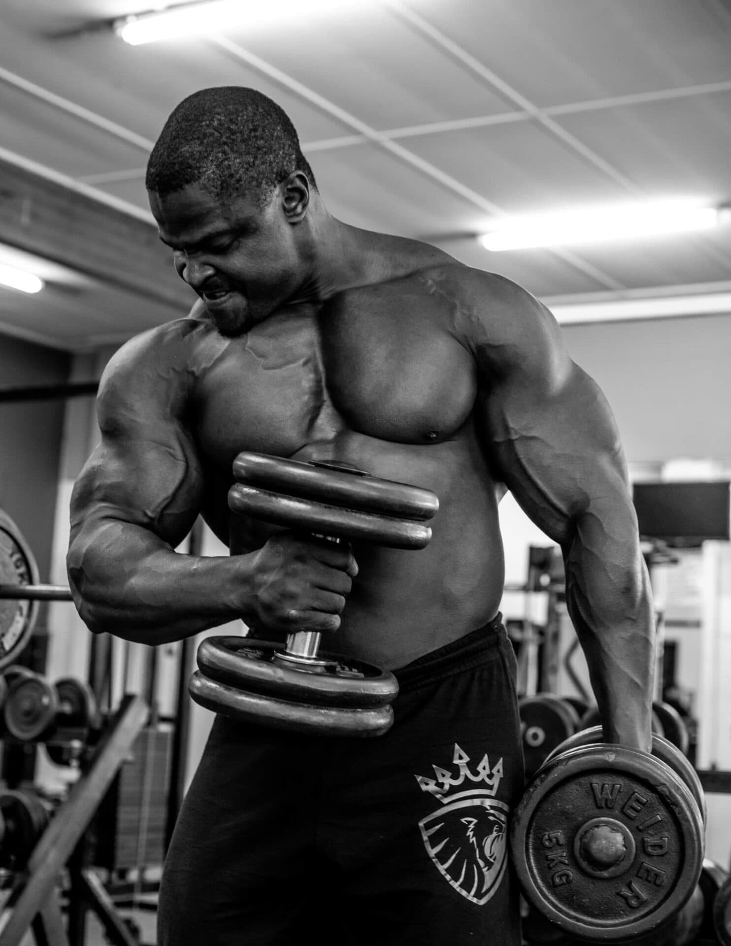Black Bull manifesto athlete holding dumbbells